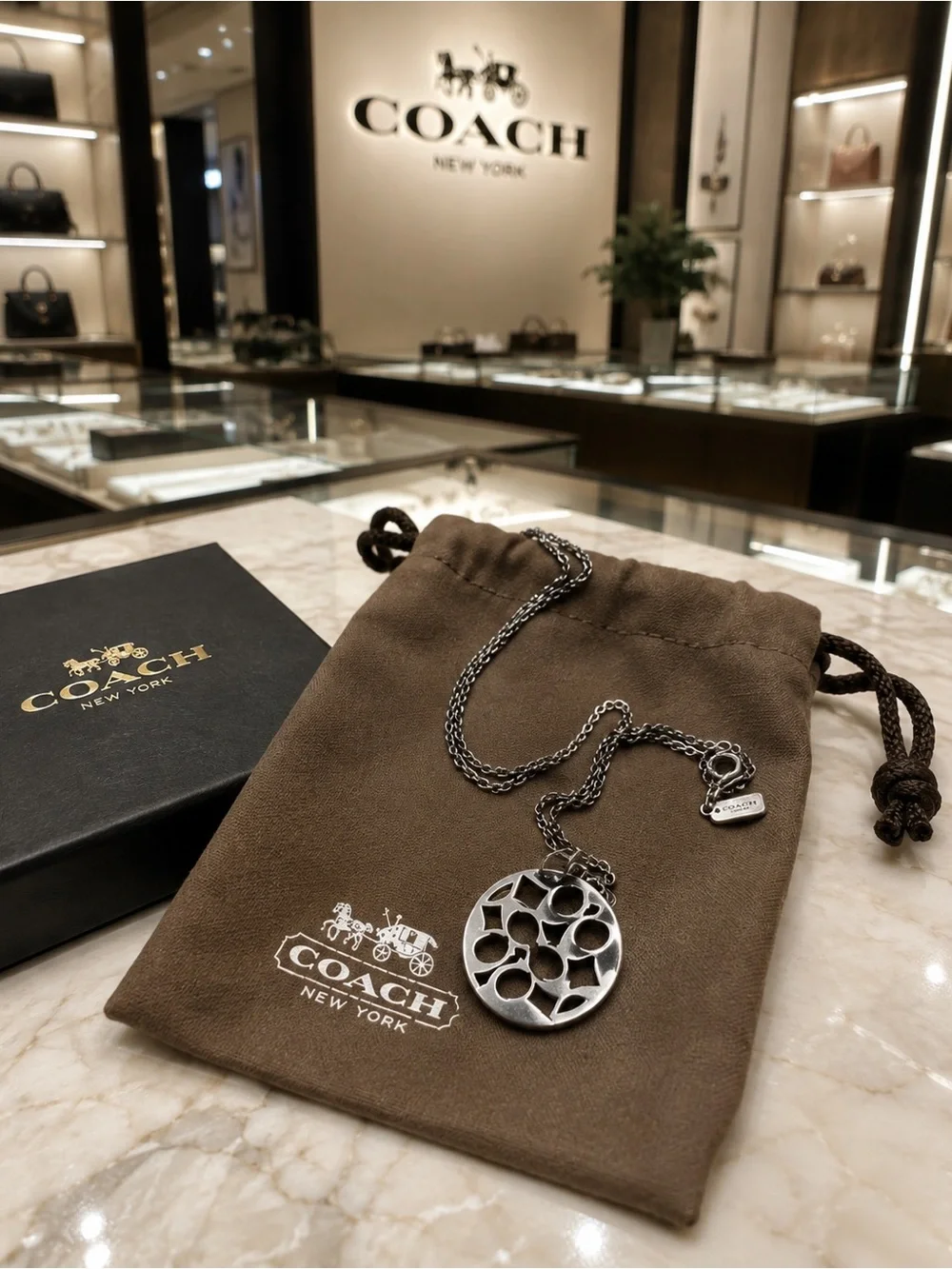 Coach Black & Silver Crystal Logo Pendant Necklace.